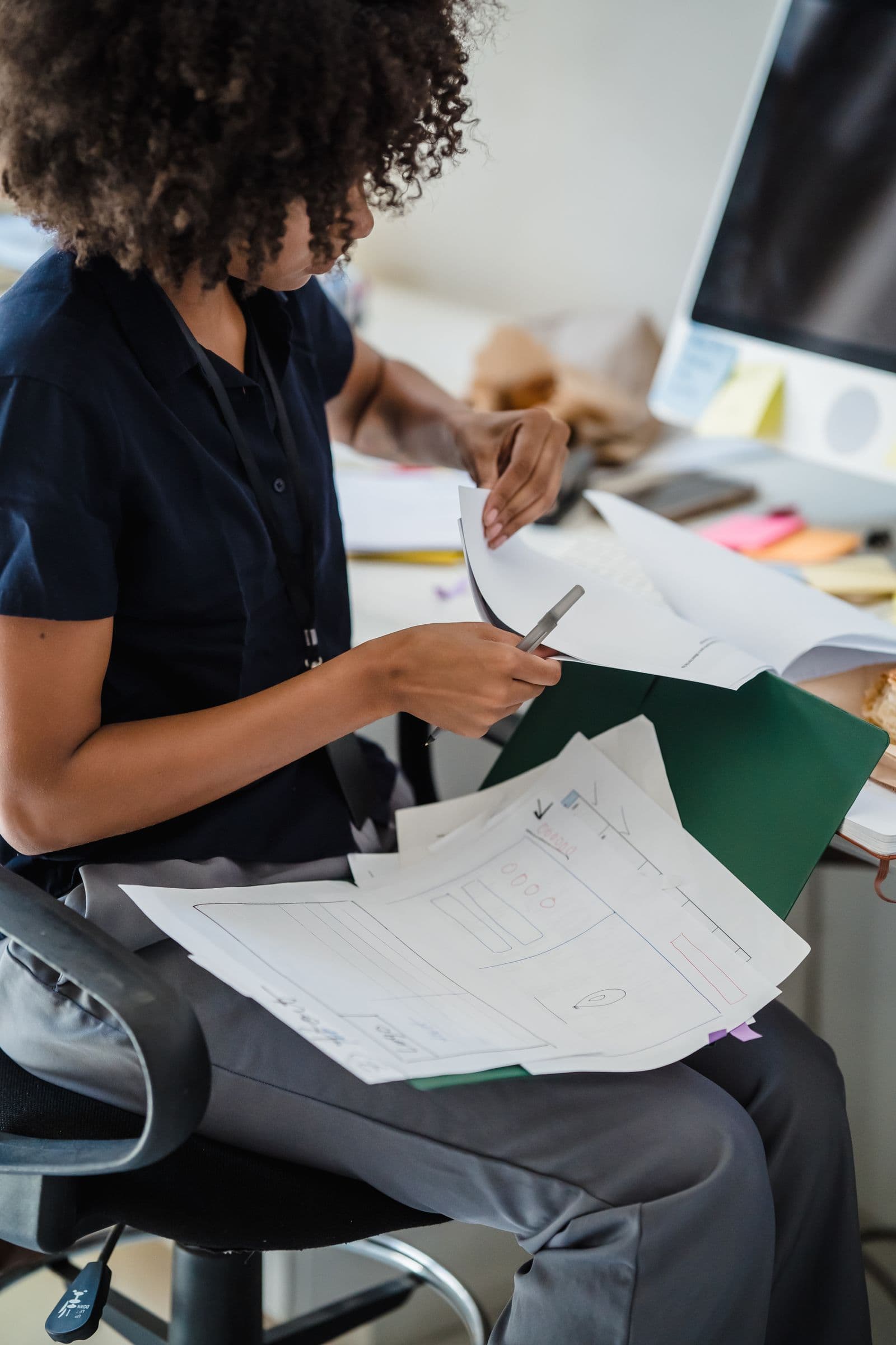 Business owner working through invoices and paperwork at a desk
