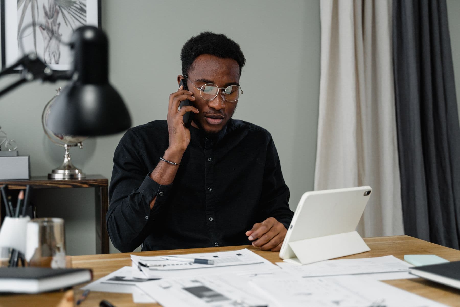 Business owner speaking to a customer on the phone at his desk